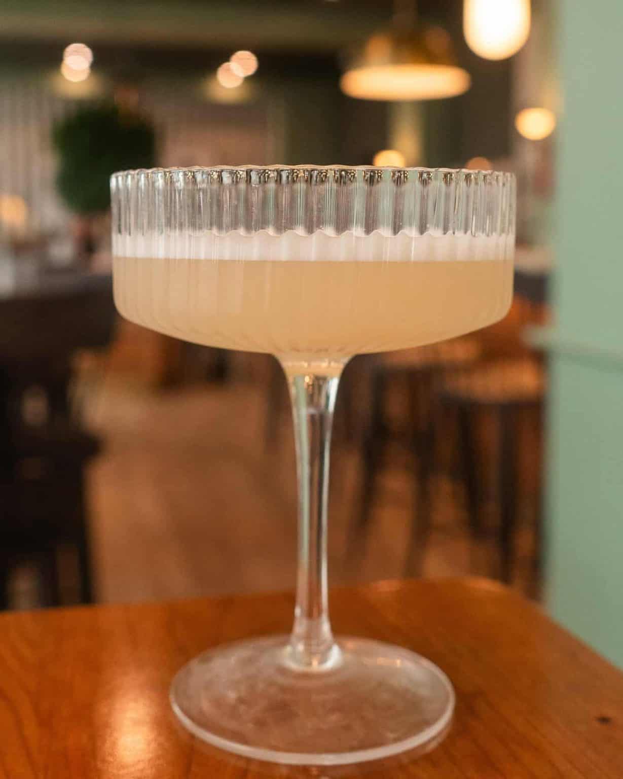 Elegant cocktail in a vintage glass at Mudpenny restaurant.