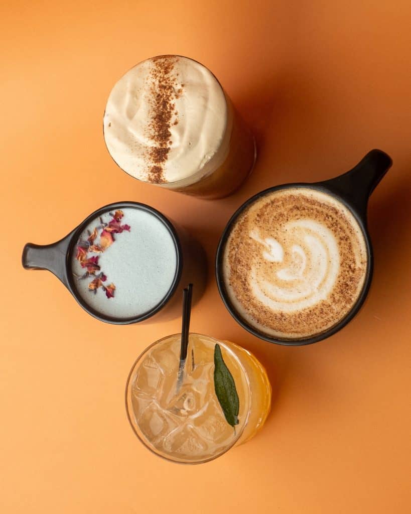 Delicious coffee drinks and sweet treats served in stylish cups at Mudpenny. Perfect for a cozy cafe.