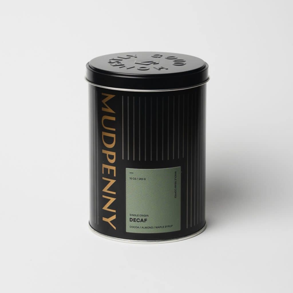Decaf coffee tin with Mudpenny branding and sleek black design.