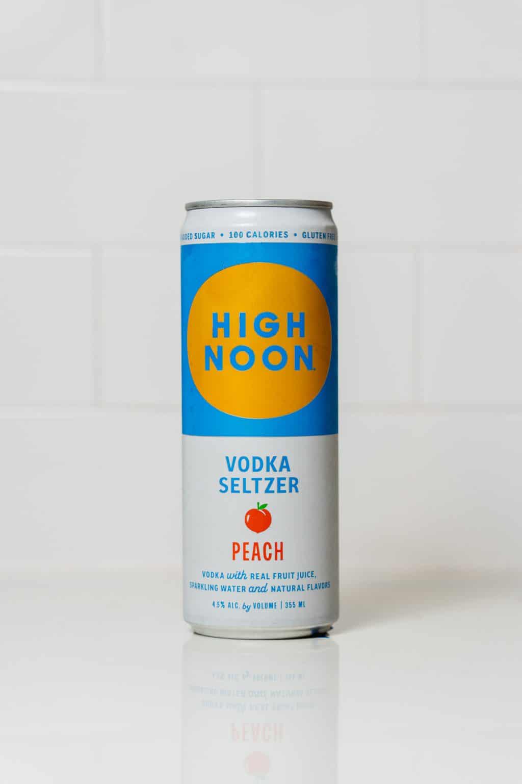 High Noon Peach Vodka Seltzer can on white background.