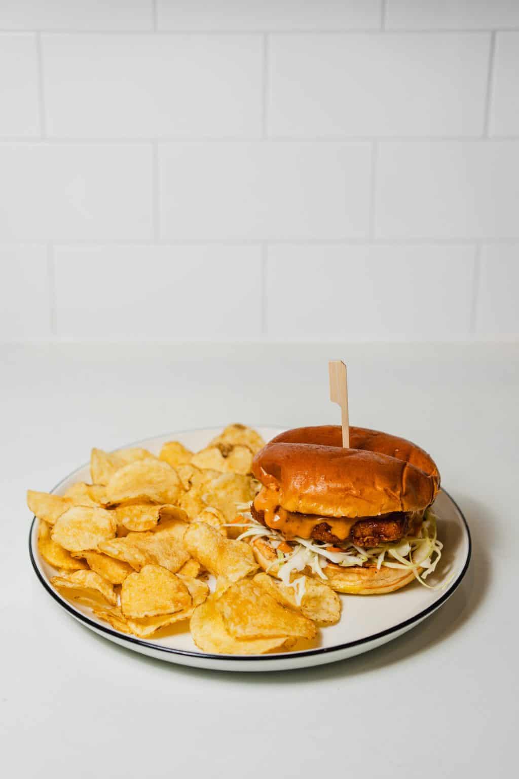 Hot honey chicken sandwich with crispy chicken and toppings.