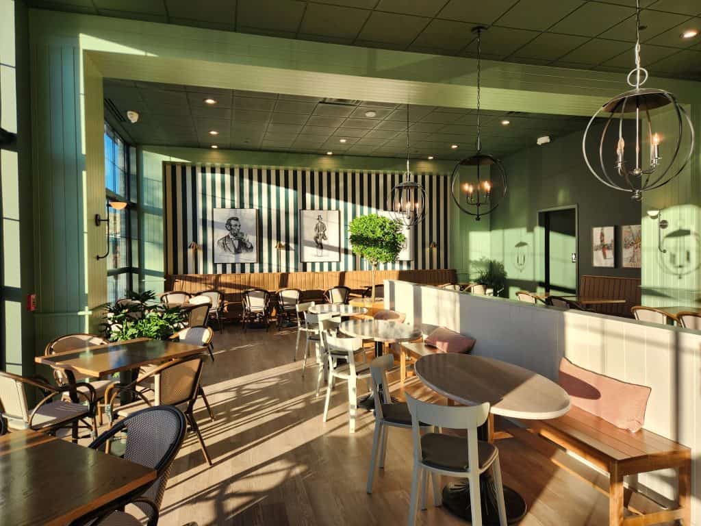 Bright cafe interior with contemporary furniture and large windows.