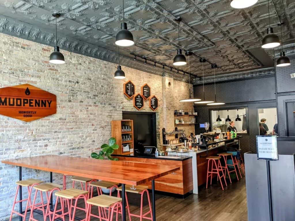 Cozy Mudpenny coffee shop with modern industrial decor and seating area.