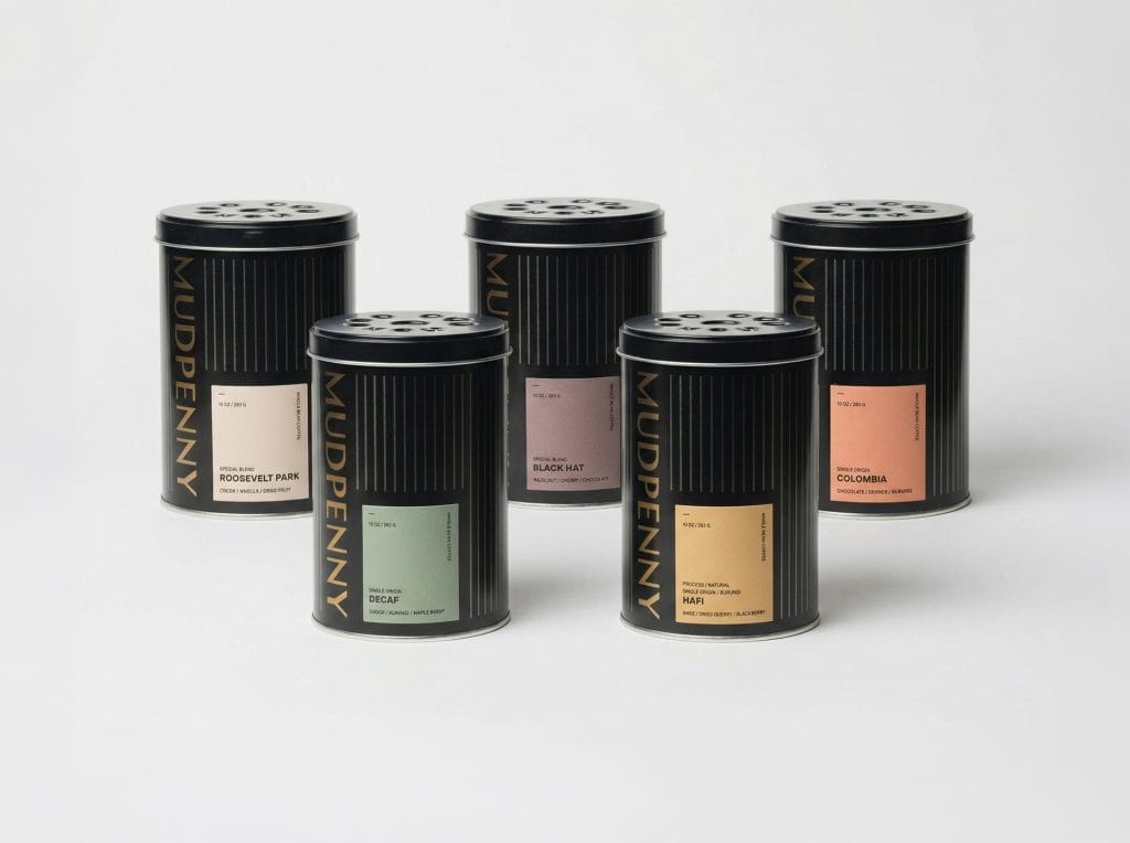 Elegant scented candles in stylish black tins for home decor.
