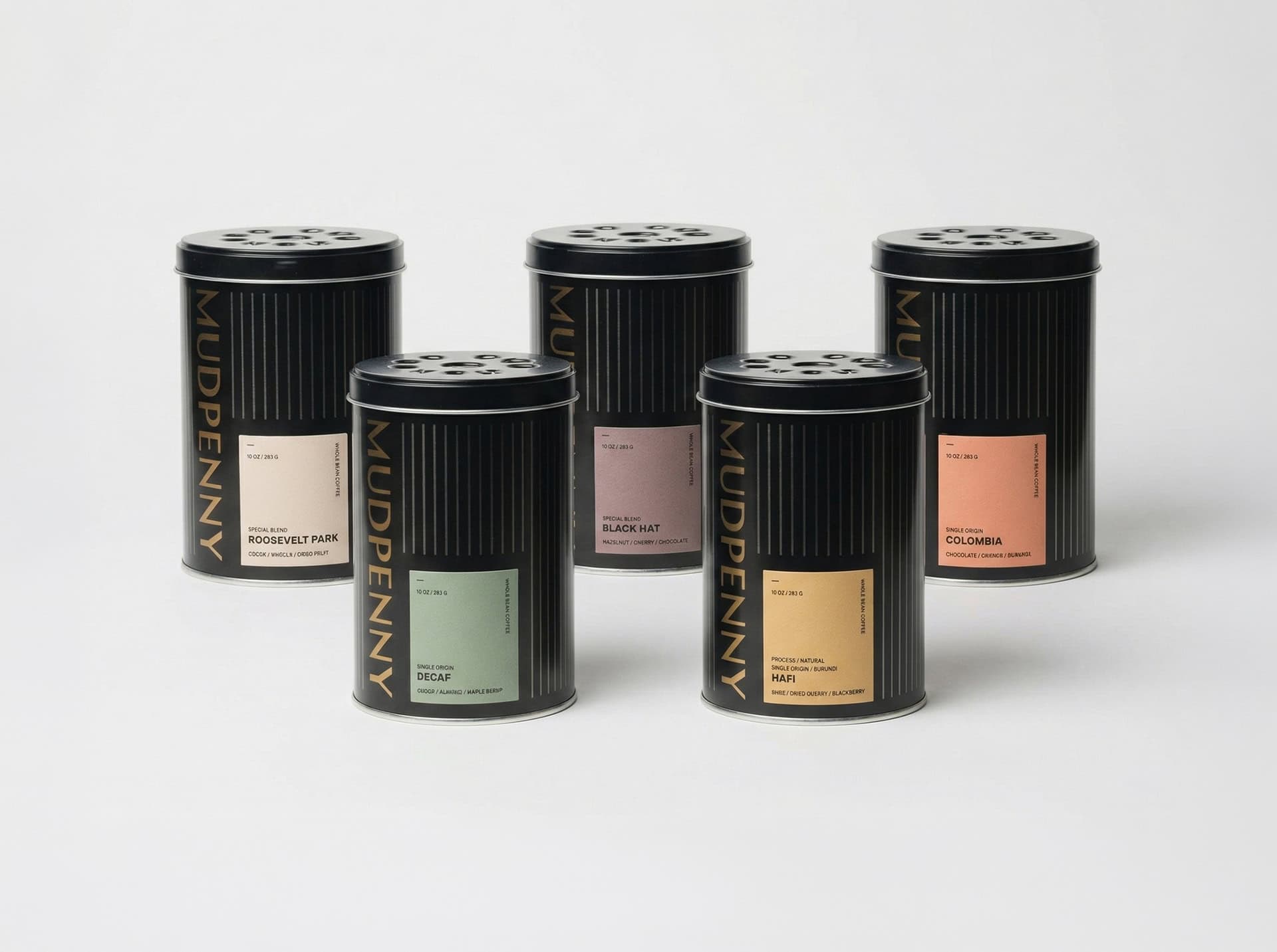 Elegant scented candles in stylish black tins for home decor.