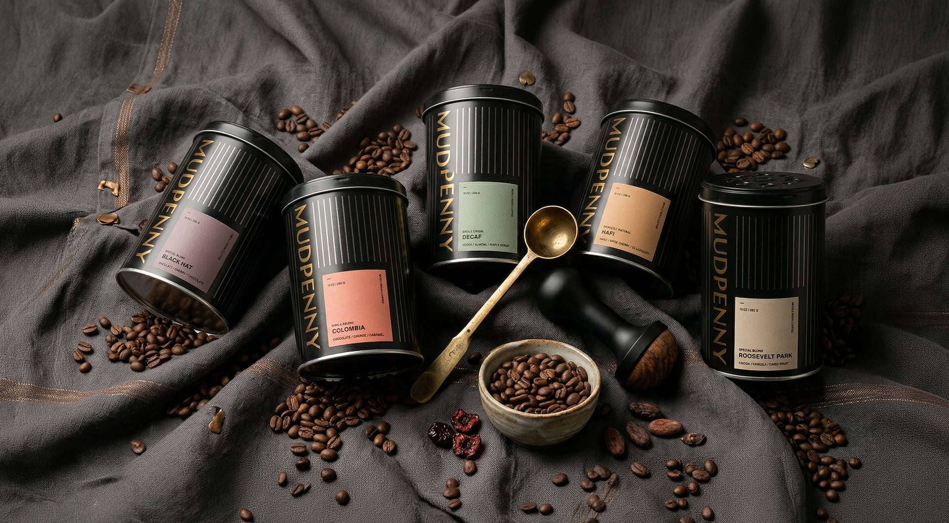 Premium Mudpenny coffee jars with roasted beans and flavors.