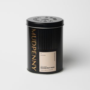 Decaf coffee tin with Mudpenny branding and sleek black design.