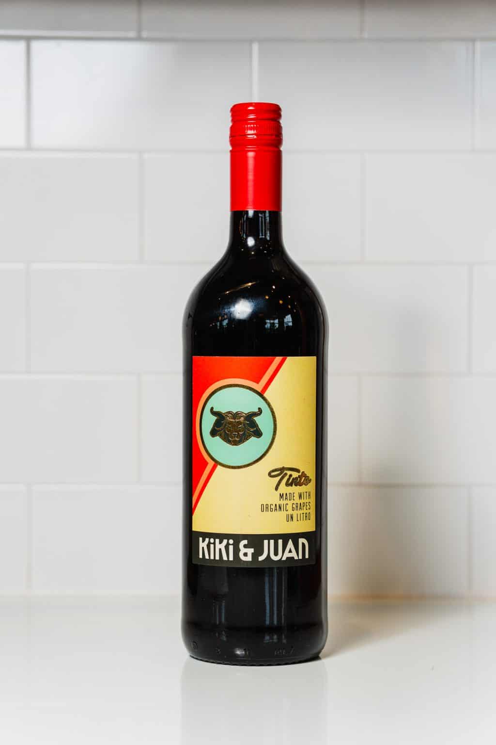 Kiki & Juan organic red wine bottle with label featuring a dog illustration.