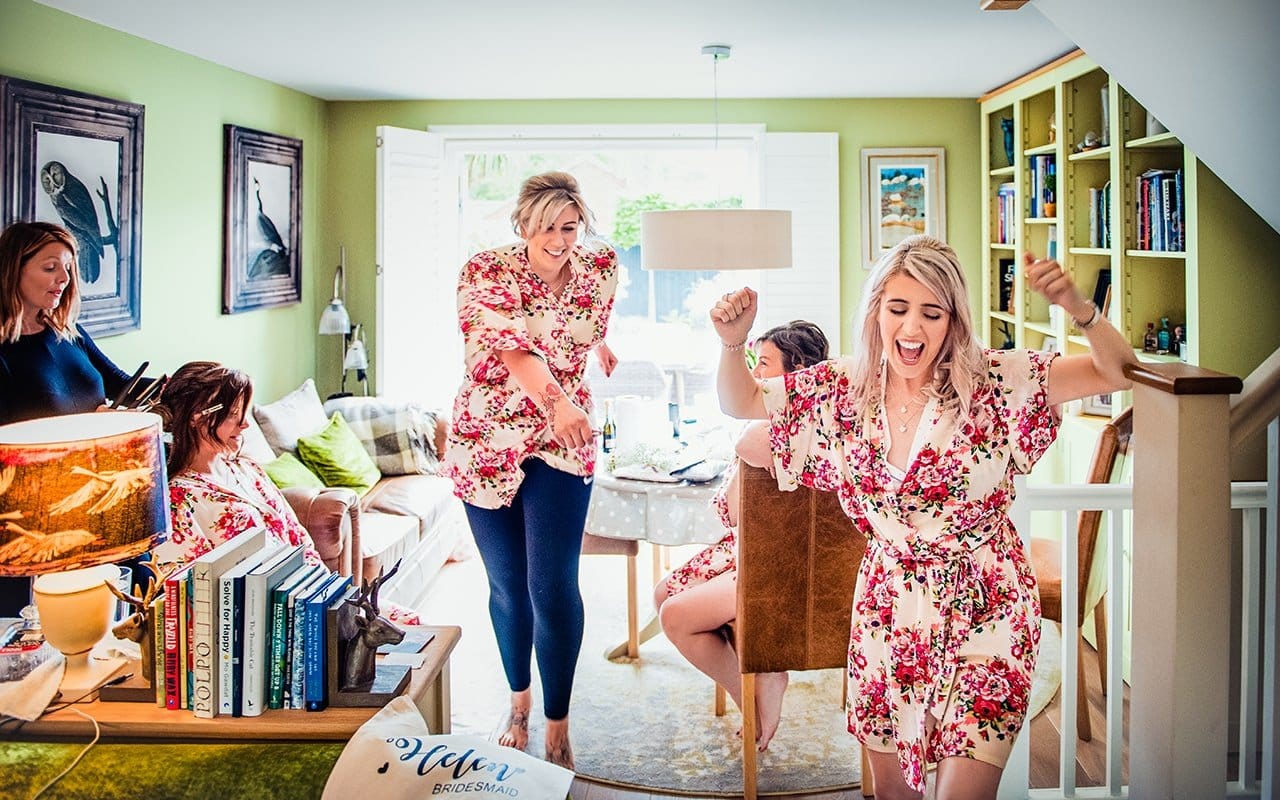 Documentary wedding photograph bride bridesmaids dancing wedding morning Dorset