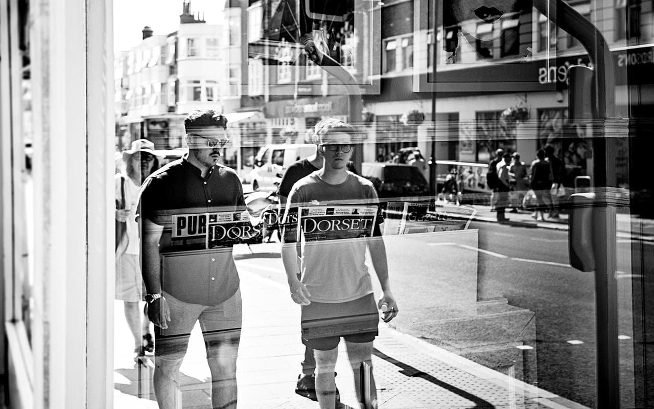 Groom best man walk down Dorset street wedding morning black white wedding photograph