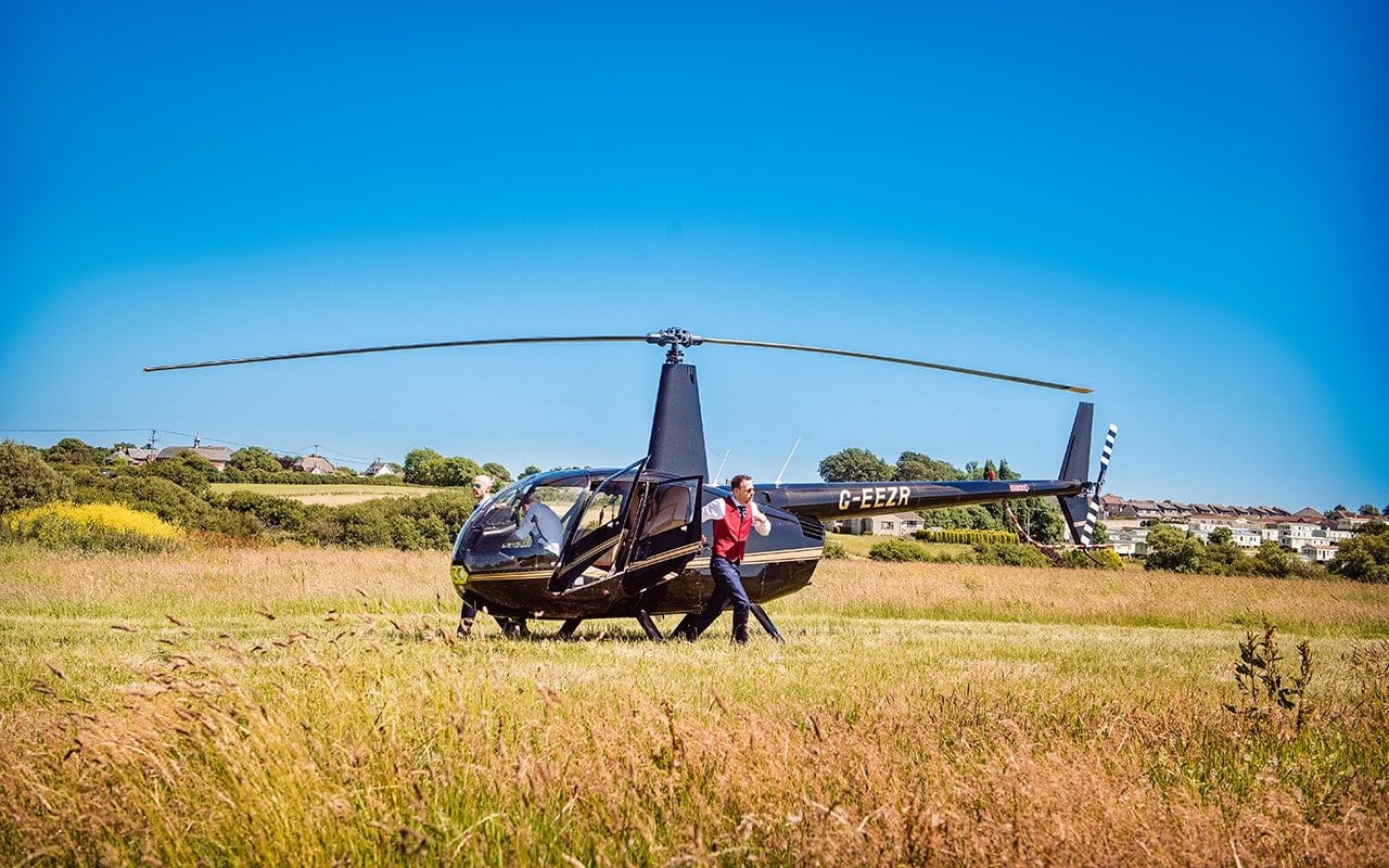 Groom helicopter wedding transport photograph one thousand words wedding photographers