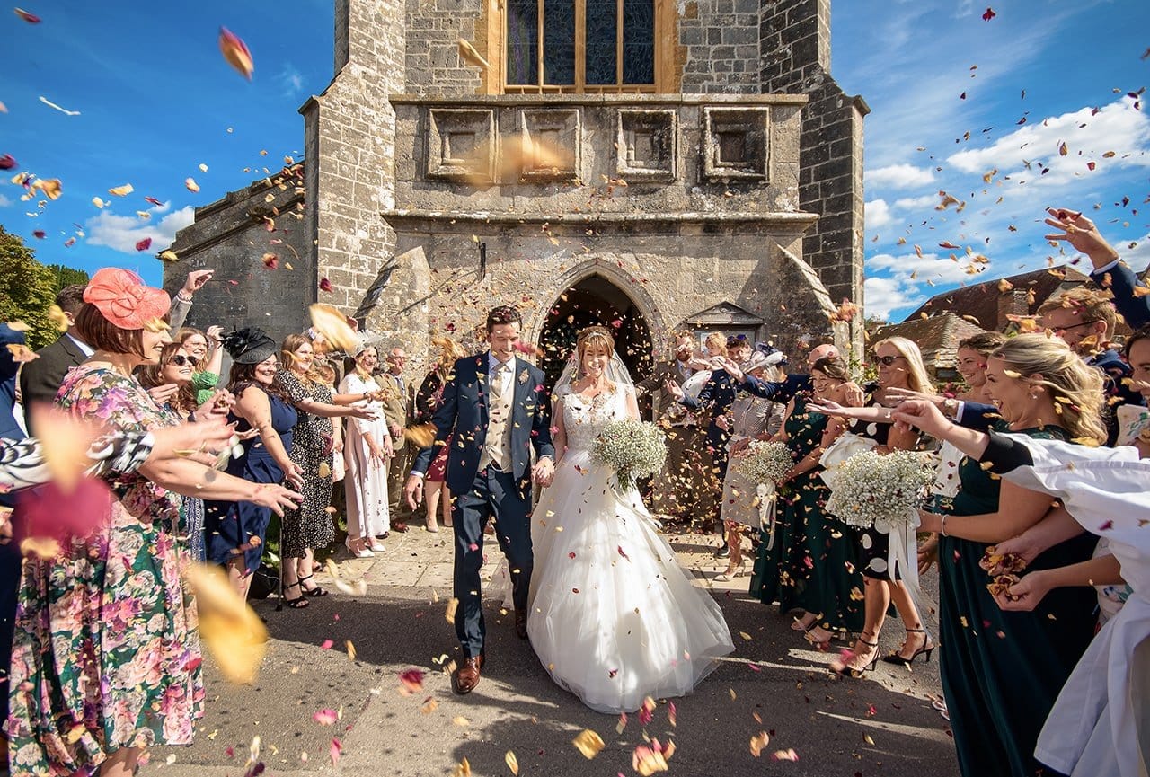 Outdoor wedding confetti photograph St Marys church Wareham Dorset