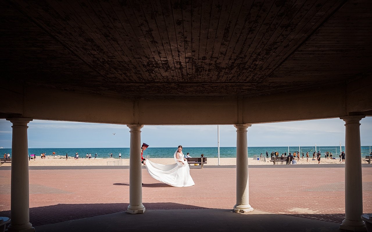 Sandbanks beach pavilion wedding photograph brides white wedding dress fanned groom seaside wedding Dorset