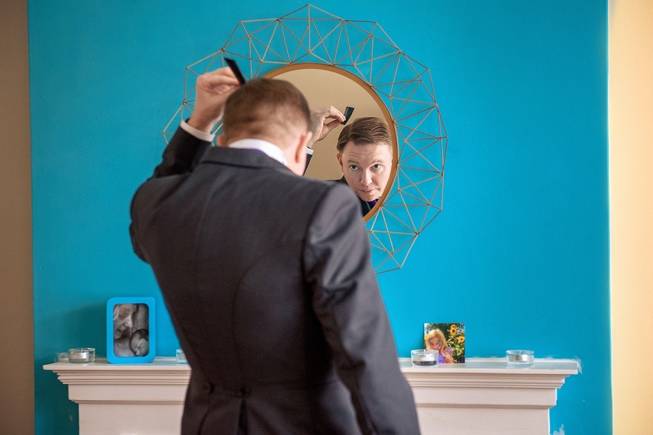 happy groom preparing wedding day mirror wedding morning two wedding photographers