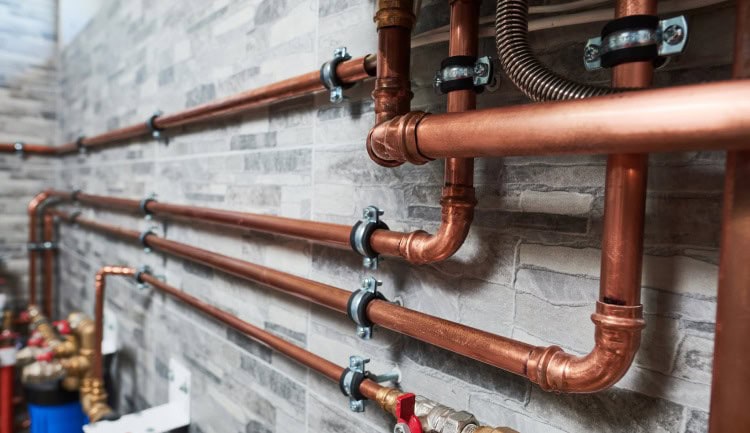 copper pipe facened to a cement wall