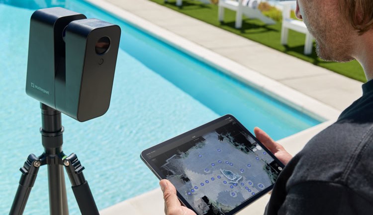 man holding ipad controlling 3d camera