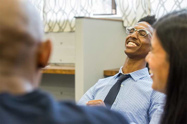 People sitting at table smiling and laughing