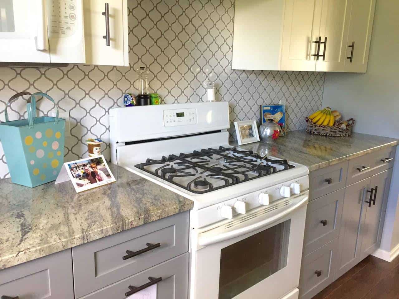 Kitchen with granite countertops, stove, and cabinets.