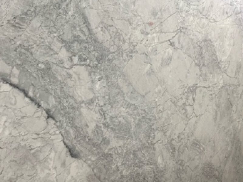 Dolomite 4 Close-up of Dolomite natural stone surface with gray and white veining.