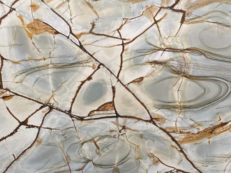 Close-up of a marble granite surface with brown and gray veining.