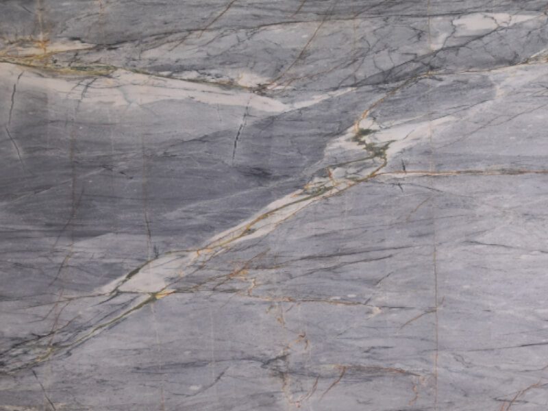 Close-up of gray marble slab with gold veining for countertops.