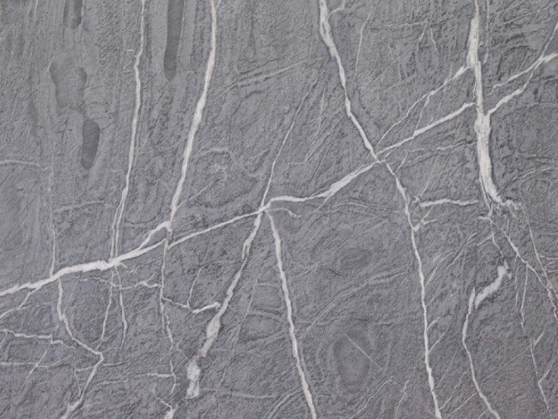 Close-up of gray marble with white veining for countertops or flooring.