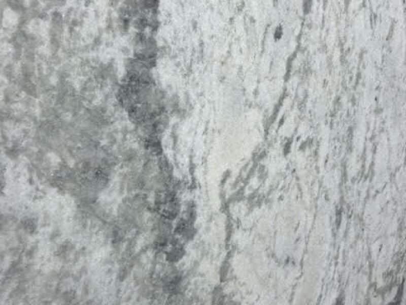 Dolomite 6 Close-up of a textured granite surface with gray and white tones.