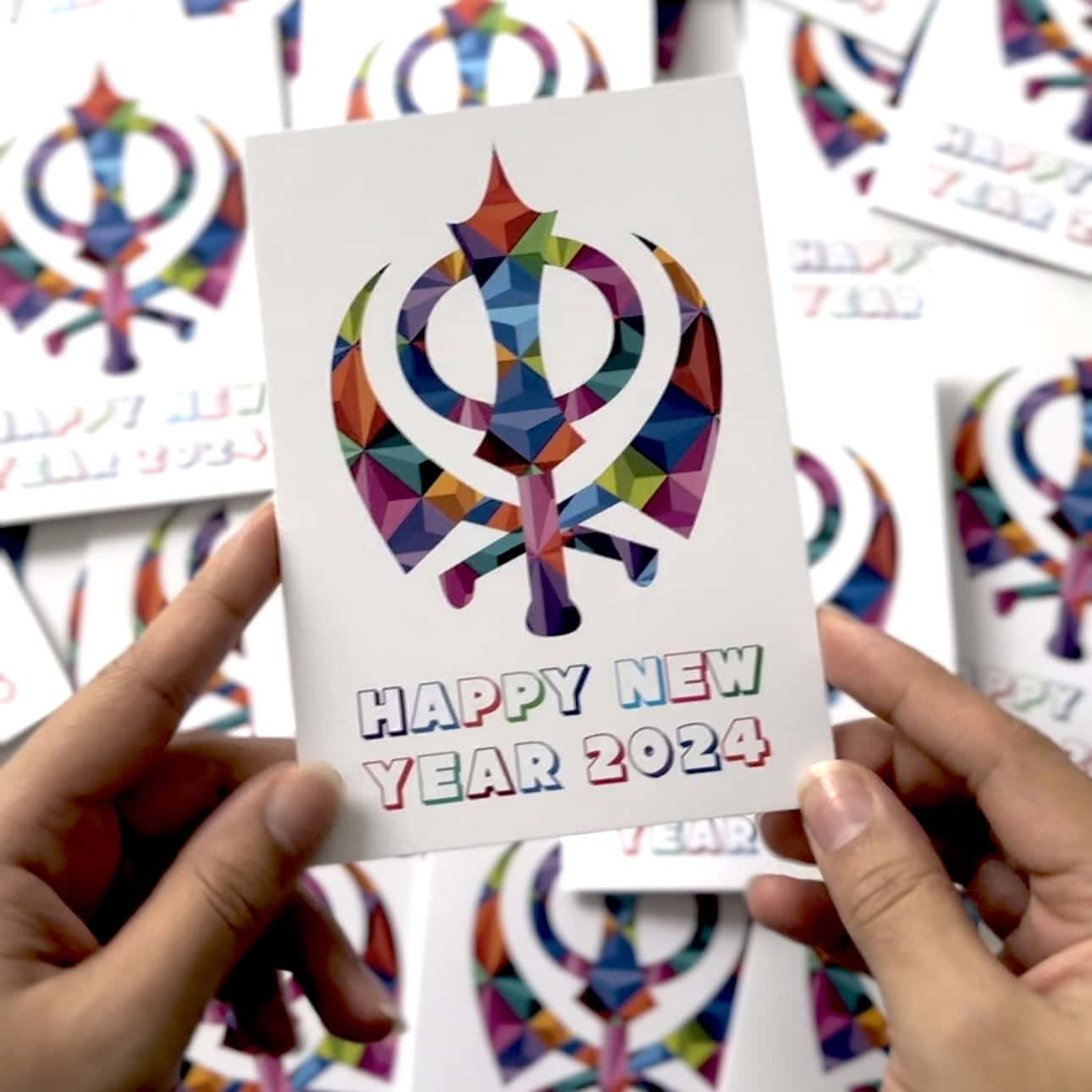 Sikh new year cards held in hands