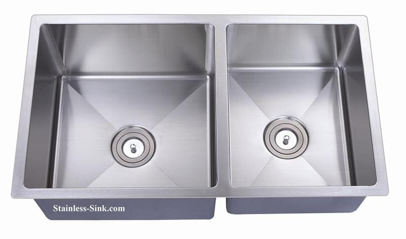 Stainless steel double kitchen sink with two basins and drain openings.