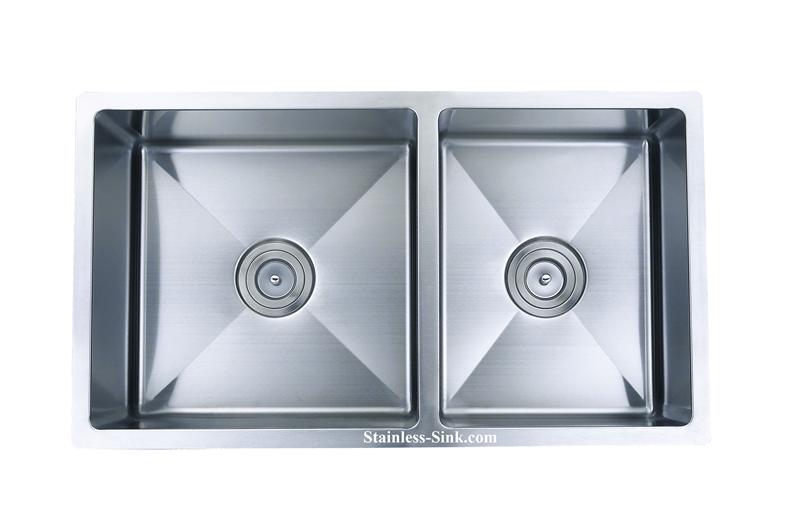 Double stainless steel kitchen sink with two basins and drain holes.