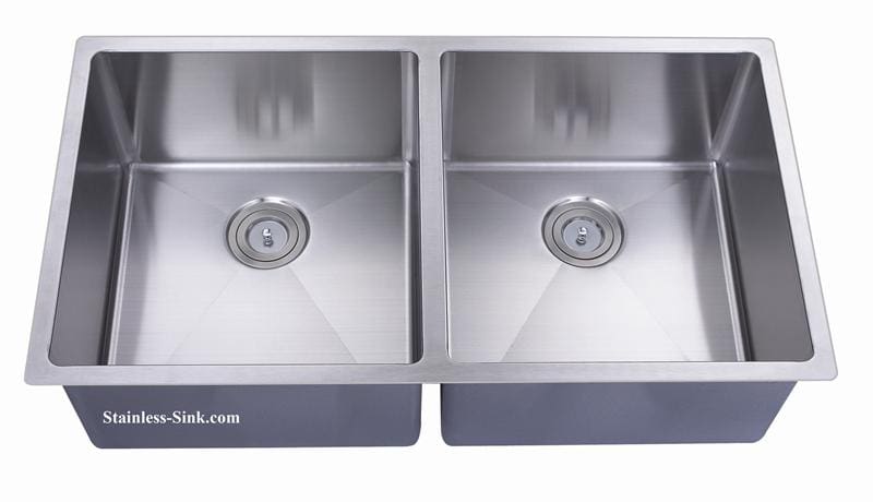 Stainless steel double kitchen sink with two basins and drain openings.