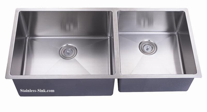 Stainless steel double kitchen sink with two basins and drain openings.