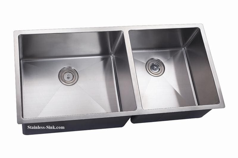 Stainless steel double kitchen sink with two basins and drain openings.