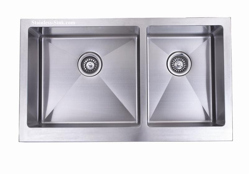 Stainless steel double kitchen sink with two basins and drain openings.
