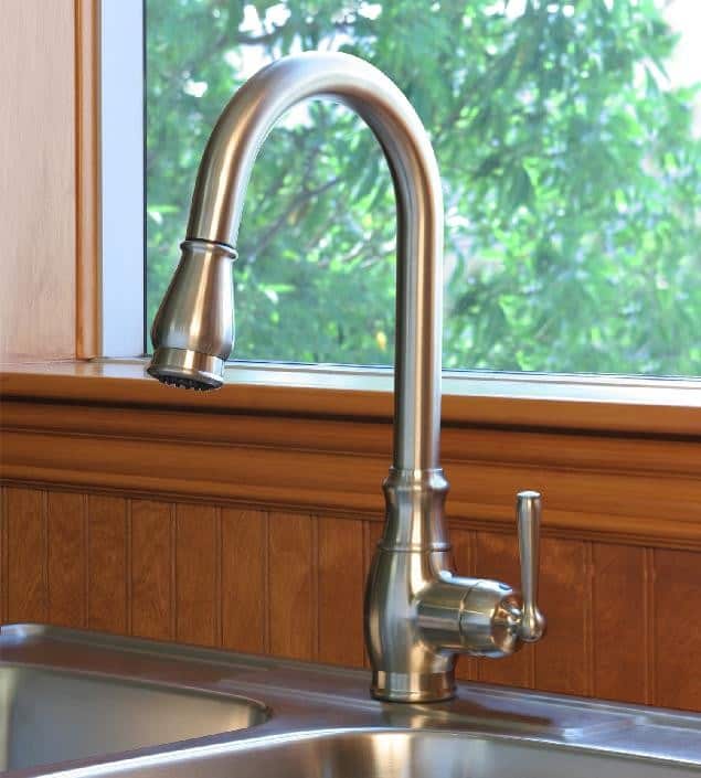 Modern stainless steel kitchen sink faucet with high arc design.