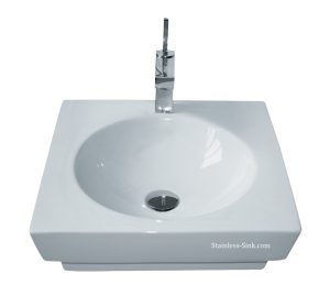 White square bathroom sink with a chrome faucet and drain.
