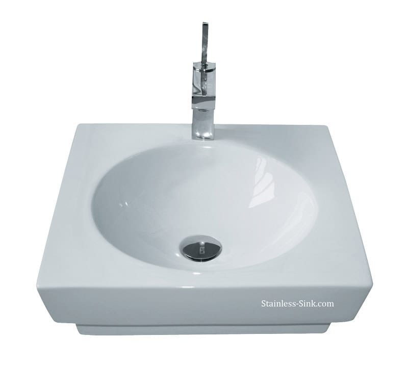 White square bathroom sink with a chrome faucet and drain.