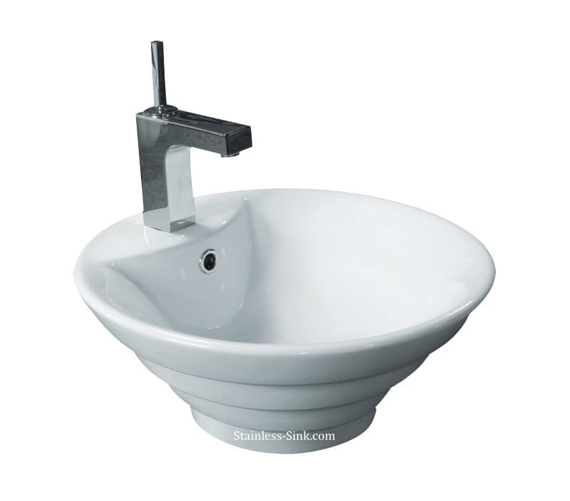 Contemporary white ceramic bathroom sink with chrome faucet and unique design.