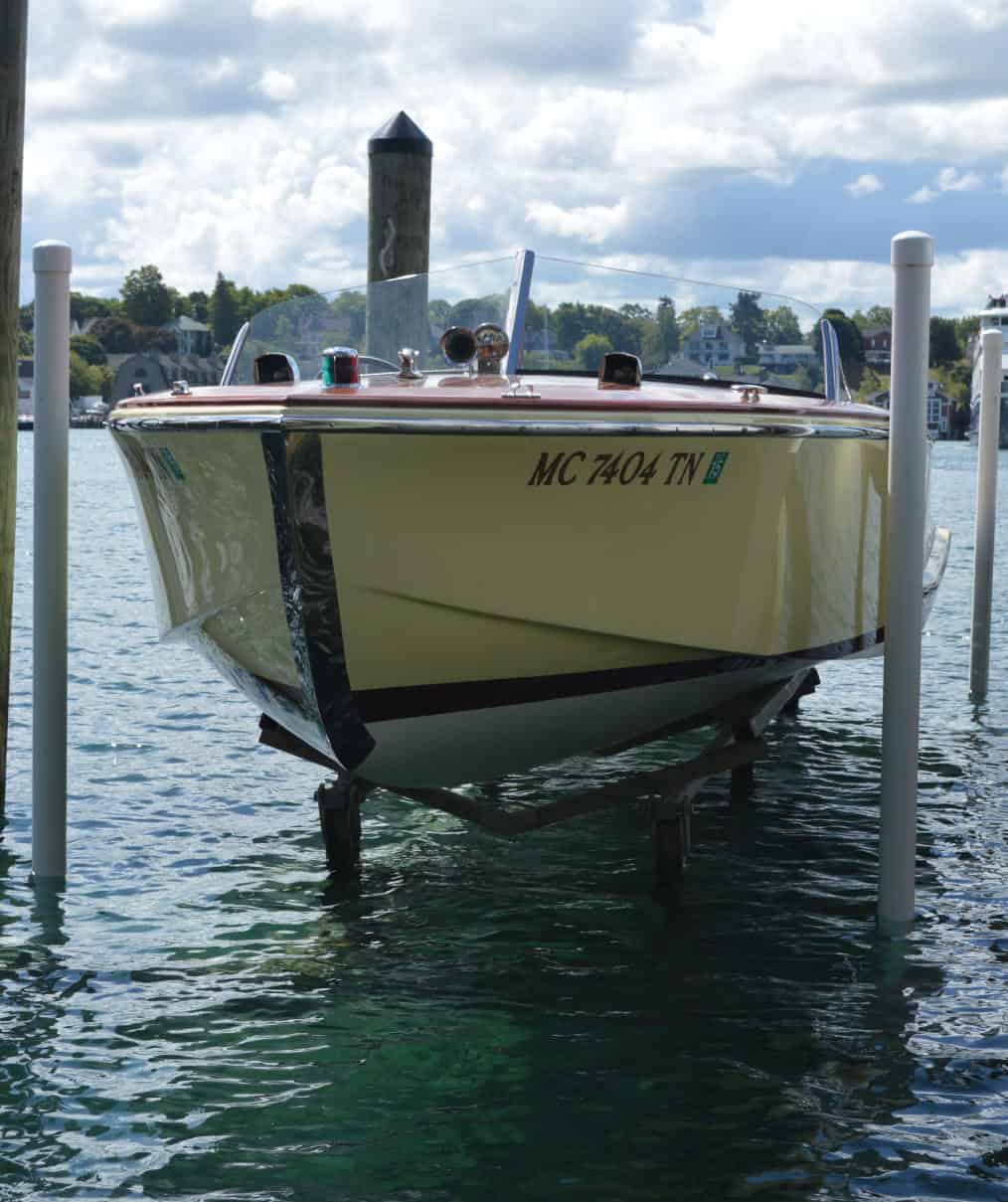 Boat docked at Summit Marine marina with calm water and a scenic background.
