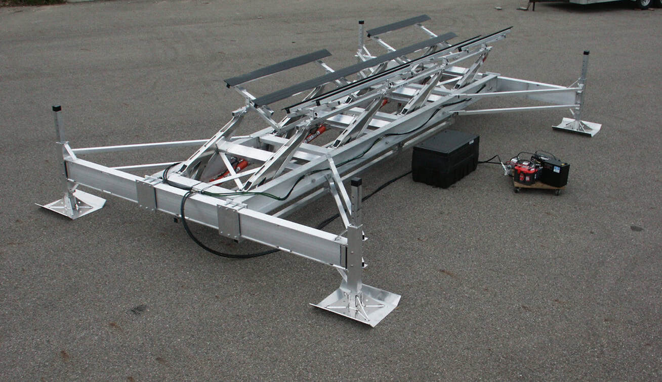 Aluminum boat lift platform with adjustable supports and hydraulic system.