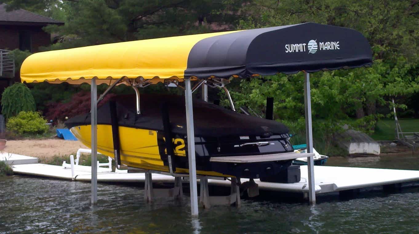 Boat lift with yellow and black boat under canopy at Summit Marine.