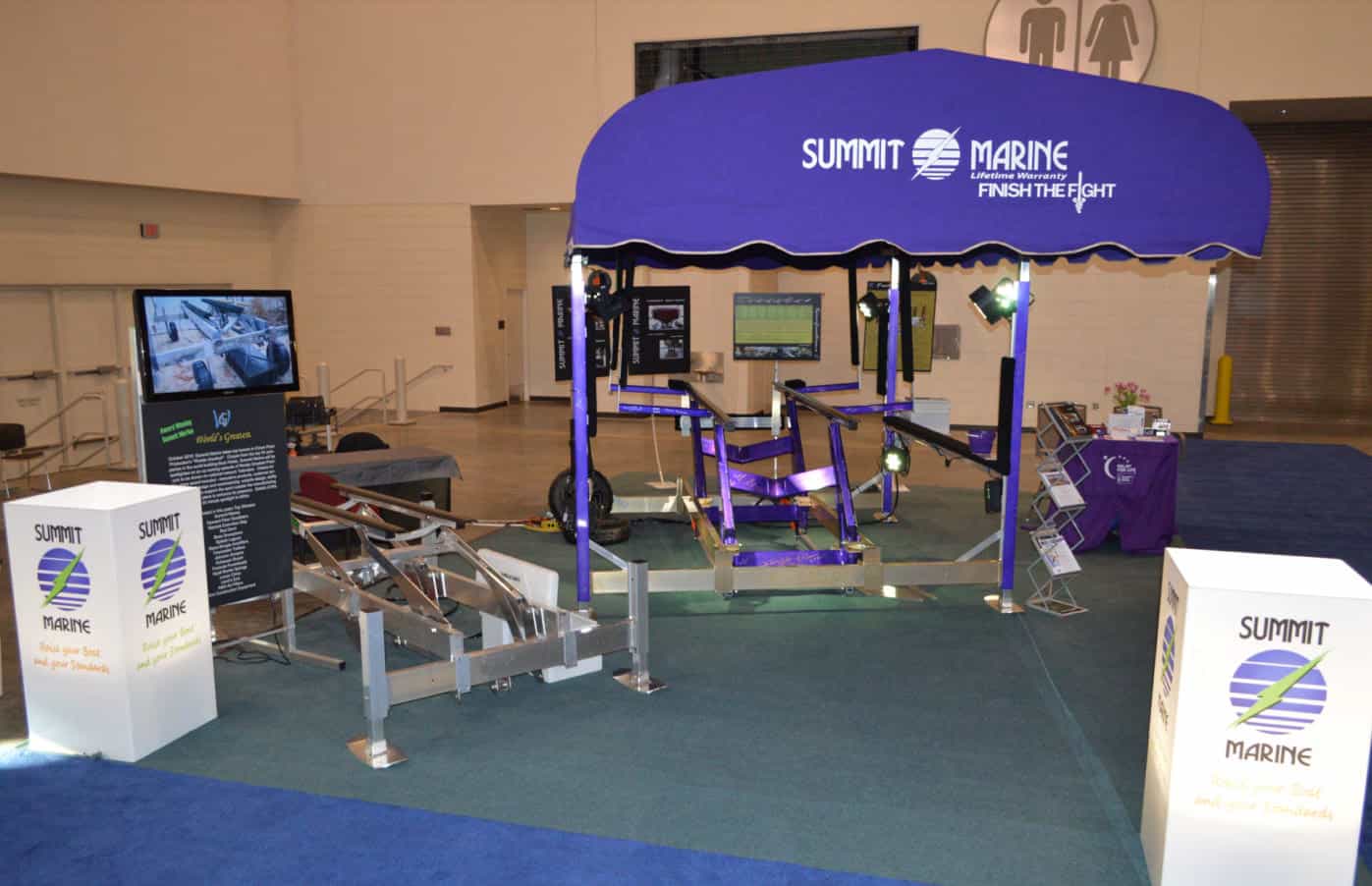 Summit Marine booth with interactive water safety and boating simulators.