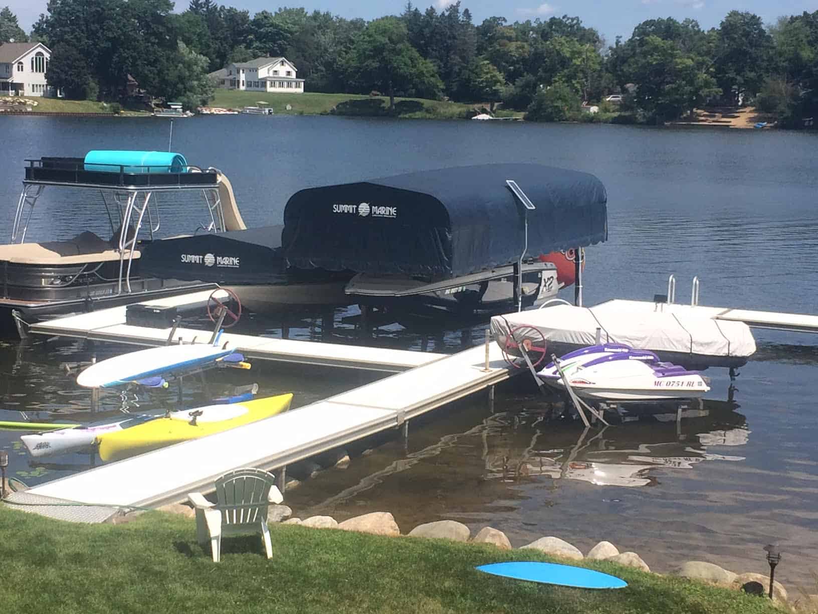 Docked boats and watercraft at Summit Marine marina on a calm lake.