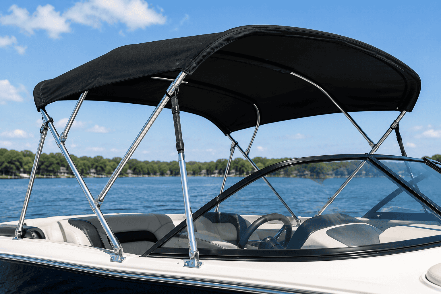 Boat with black Bimini top on a calm lake under blue sky.