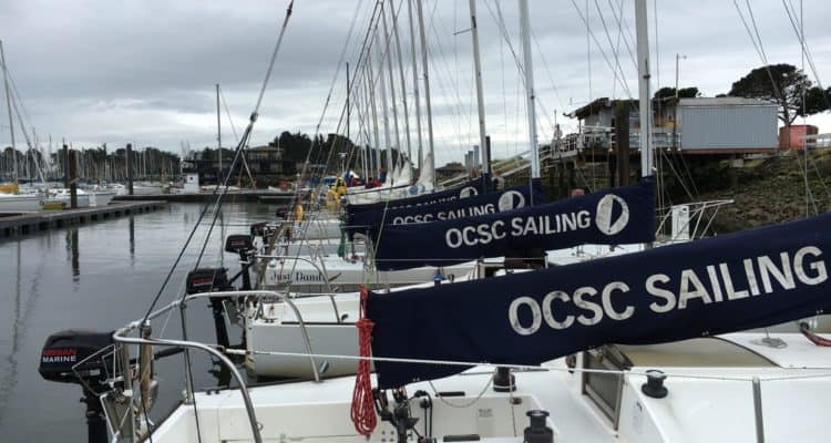 J24 main sail covers lined up at OCSC Sailing School