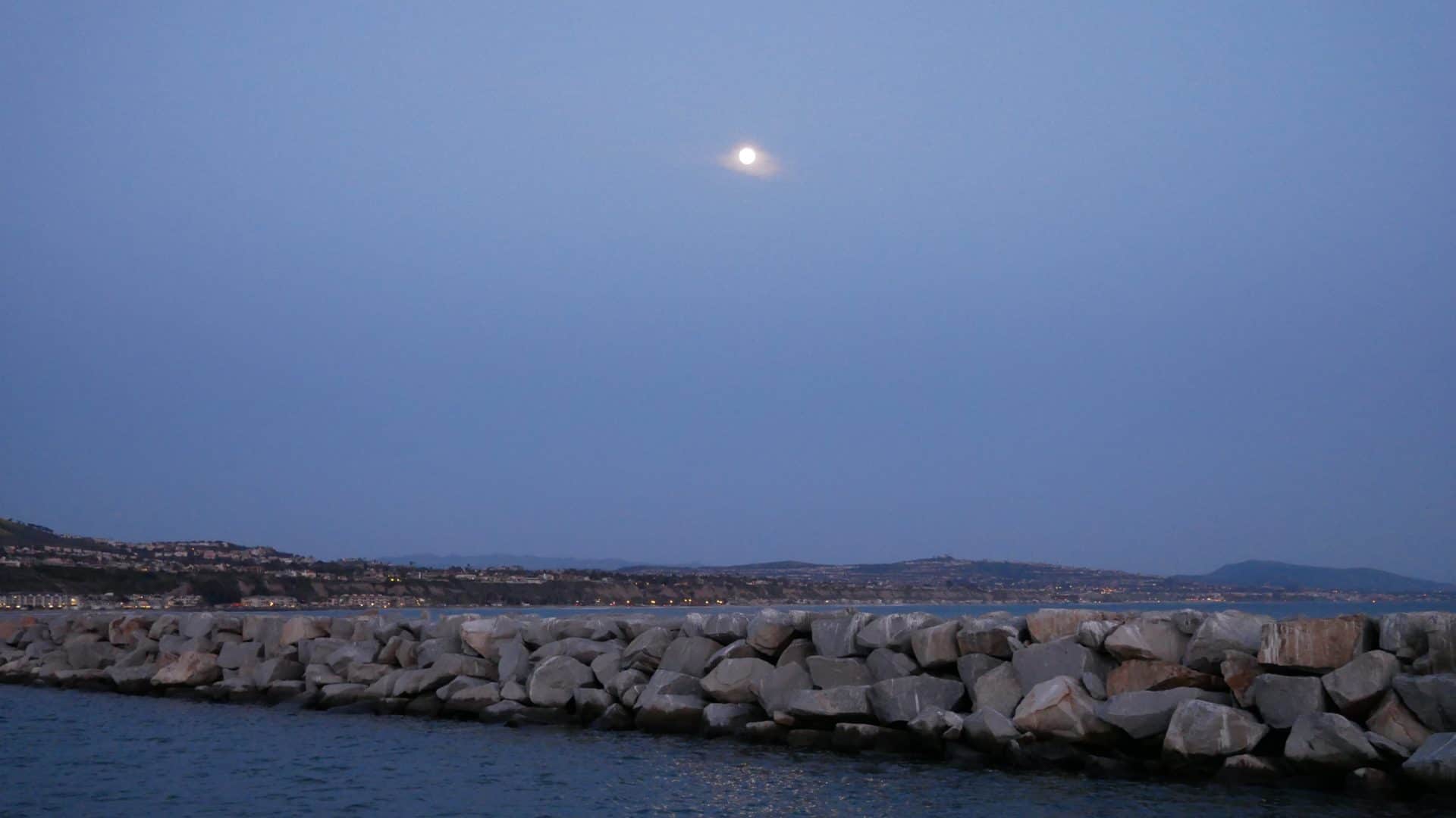 Breakwater with moon at Dana Point, California
