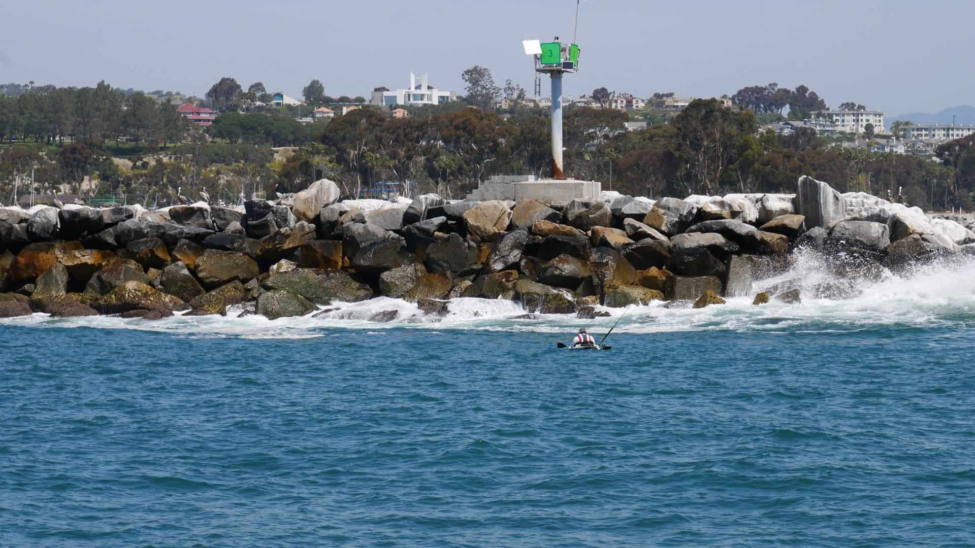 Kayaker fishing near the breakwater