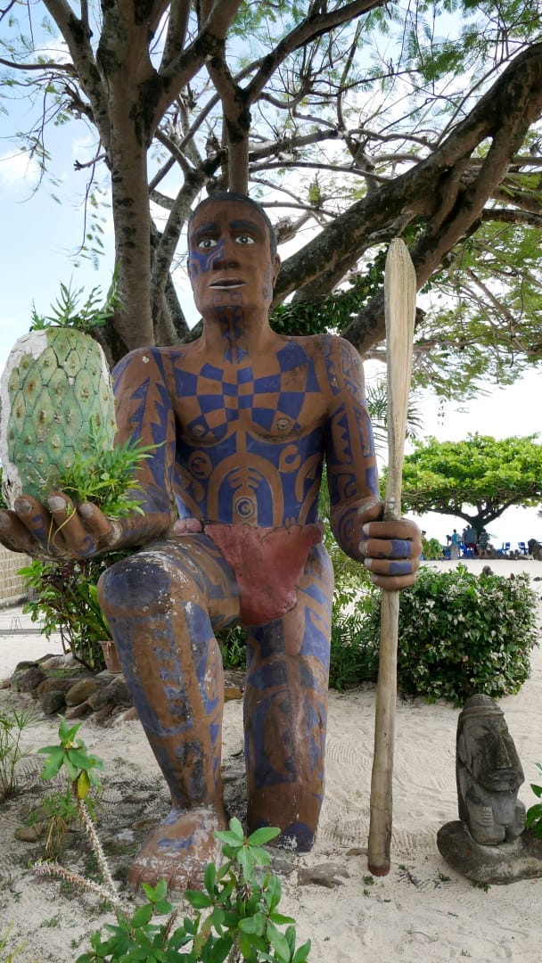 Tall Moorean statue in front of decorative trees