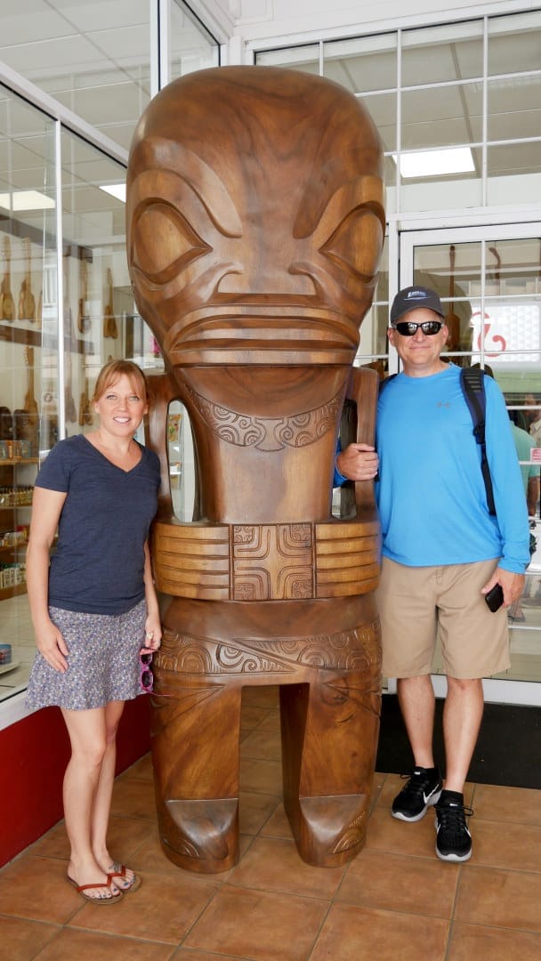 Emily and Lou standing with tall tiki statue