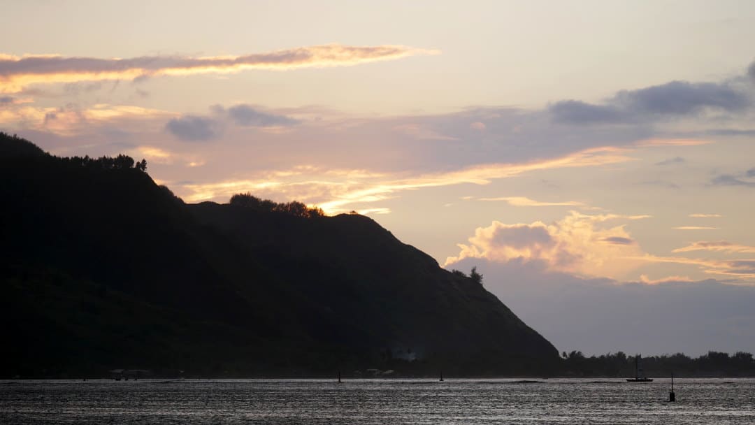 Sunset over the cliffs oceanside in Moorea